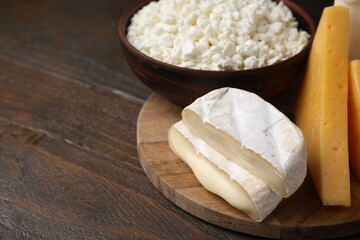 Dairy products. Different kinds of cheese on wooden table, closeup. Space for text