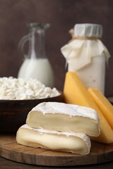 Dairy products. Milk and different kinds of cheese on wooden table, closeup