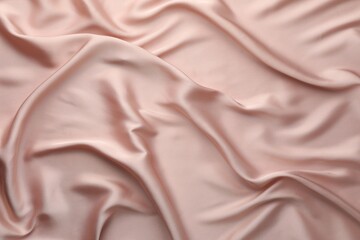 Crumpled pink silk fabric as background, top view