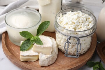 Different dairy products and mint on table