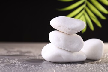 White spa stones with water drops on grey background. Space for text