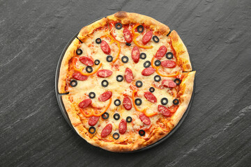 Tasty pizza with cheese, dry smoked sausages, olives and pepper on grey table, top view