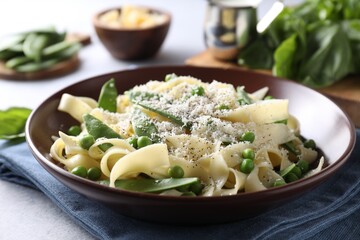 Delicious pasta with green peas on grey table, closeup