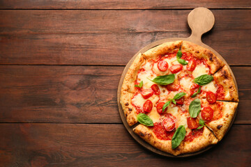 Delicious Margherita pizza on wooden table, top view. Space for text