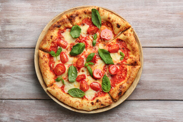Delicious Margherita pizza on wooden table, top view