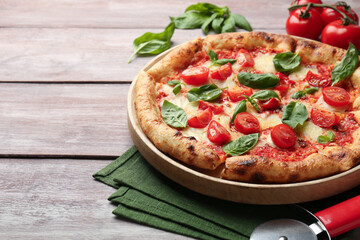 Delicious Margherita pizza on wooden table, closeup. Space for text