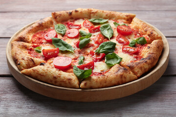Delicious Margherita pizza on wooden table, closeup