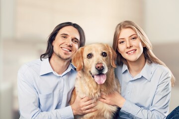 Happy couple embracing their dog, lifestyle concept