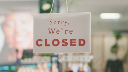 Extreme close up shot of message on fashion boutique door announcing customers that shop is closed....