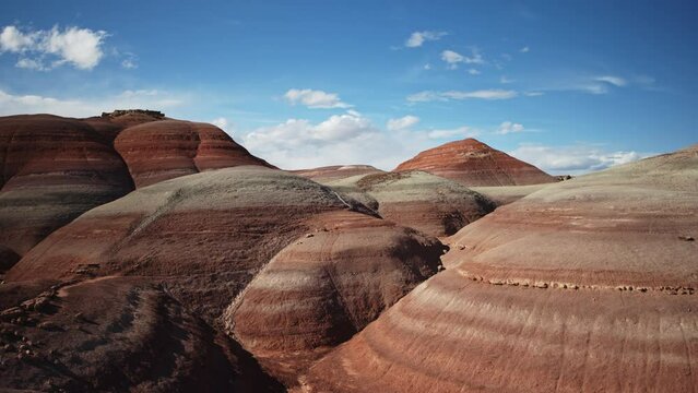 Aerial flyover view of colorful Bentonite Hills / Caineville, Utah, United States