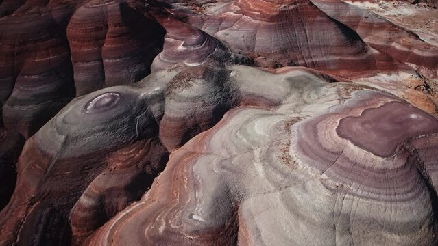 High angle aerial flyover view of colorful Bentonite Hills / Caineville, Utah, United States