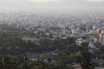 The Temple of Hephaestus with the city of Athens, Greece, behind it.