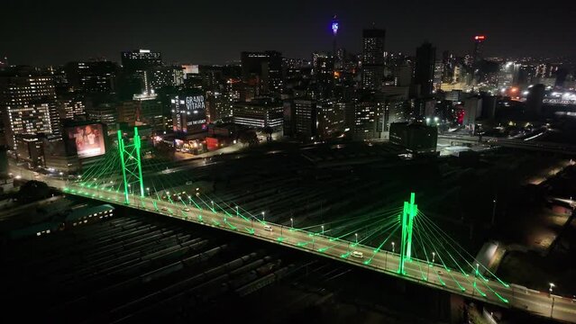 Nelson Mandela Bridge At Johannesburg In Gauteng South Africa. City At Night Landscape. Illuminated Cable Bridge. Johannesburg At Gauteng South Africa. Landmark Buildings. Colored Bridge.