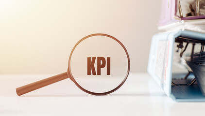 A magnifying glass focused on the word KPI, representing Key Performance Indicator, a metric used...