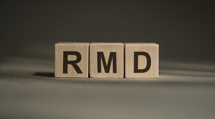 RMD - short for Required Minimum Distribution. wooden cubes. blocks lie on a black background