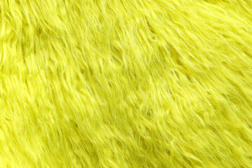 Texture of yellow faux fur as background, closeup