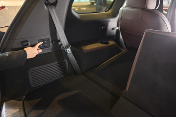 Car back seat with headrest and arm rest, a comfortable automotive fixture 3rd row recline button in car