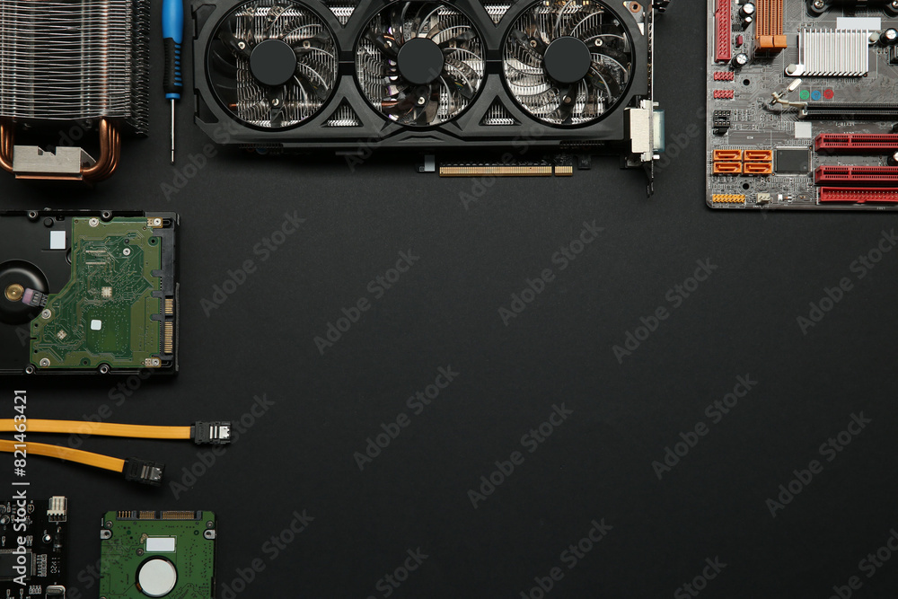 Fototapete graphics card and other computer hardware on black background, flat lay. space for text