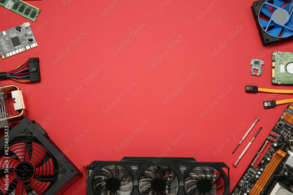 Fototapete graphics card and other computer hardware on red background, flat lay. space for text
