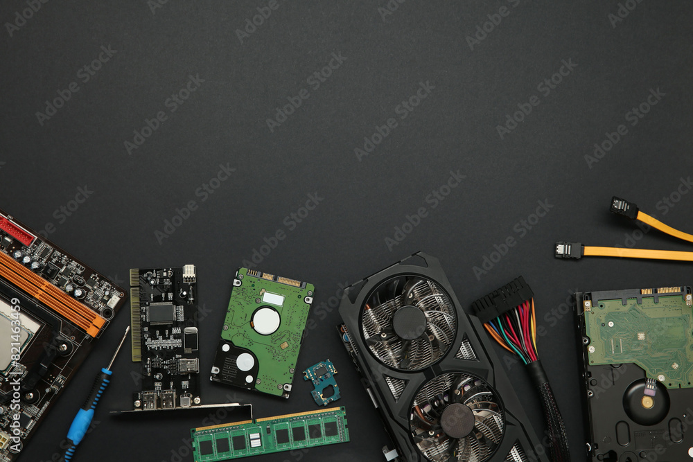 Fototapete graphics card and other computer hardware on black background, flat lay. space for text