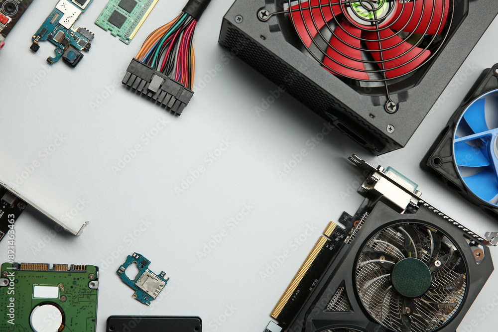 Fototapete graphics card and other computer hardware on light background, flat lay. space for text