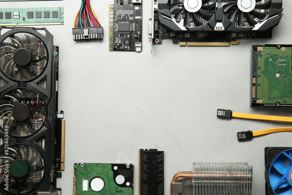 Fototapete frame of graphics card and other computer hardware on gray textured background, flat lay. space for 