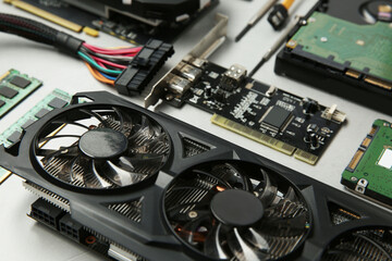 Graphics card and other computer hardware on gray background, closeup