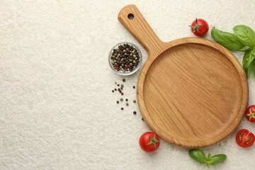 Cutting board, basil, spices and tomatoes on white textured table, flat lay. Space for text