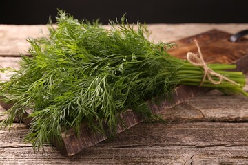 Bunch of fresh dill on wooden table, closeup