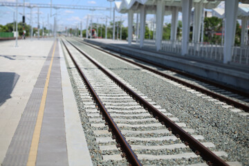 Fototapeta premium Sunny afternoon at a modern, empty train station in urban area