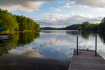 Looking out onto a Wisconsin northwoods lake as the last rays of sunlight begin to fade.  Many boats have returned from fishing.