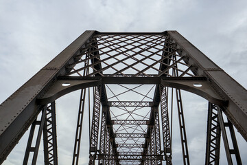 steel railway bridge detail (old rusty metal i beams bars) on rail trail converted from putnam railroad (biking and walking path) croton aqueduct geometric industrial symmetrical infrastructure heavy © Yuriy T