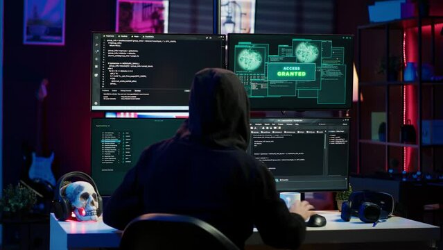 Happy man writing code on PC, celebrating after managing to get past security systems. Hacker using computer to make scripts that can hack devices, feeling proud after breaching firewall, camera A