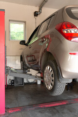 Car lift under a car for under the bottom of a car. The car is top notch. mechanical tools for car...