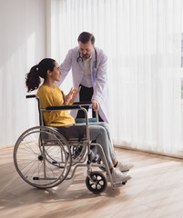 Portrait health care latin american woman sick sit wheelchair with man doctor caucasian two people...