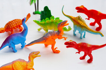 Plastic dinosaur toys on white background