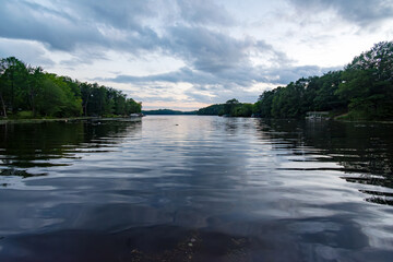 Looking out onto a Wisconsin northwoods lake as the last rays of sunlight begin to fade.  Many boats have returned from fishing for the evening