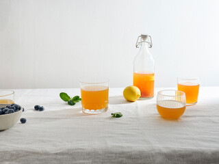 Homemade fermented kombucha drink  with fruit flavour on white background
