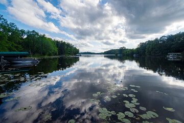 Looking out onto a Wisconsin northwoods lake as the last rays of sunlight begin to fade.  Many boats have returned from fishing for the evening.