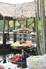 table cheeses paes finger food grapes and salads party buffet wedding decoration dishes flowers arrangements restaurant dining table