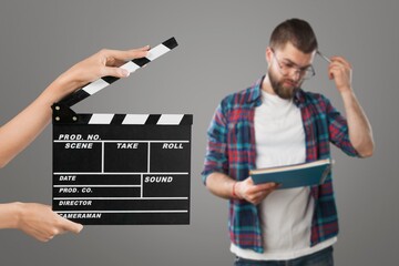 Actor performing on background of film clapperboard