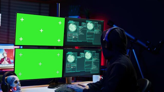 Happy man writing code on green screen PC, celebrating after managing to get past security systems. Joyous hacker feeling proud after breaching firewall using mockup computer, camera B