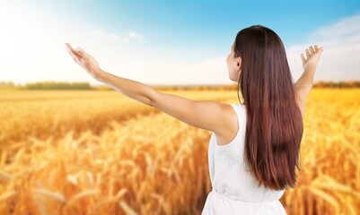 Young woman in meadow relax at sun