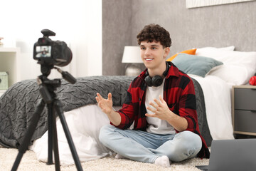 Smiling teenage blogger explaining something while streaming at home