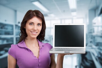 Young happy woman winner with laptop computer