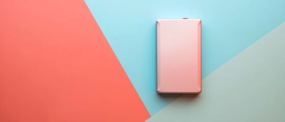 Sleek pink portable charger on a colorful geometric background, perfect for modern tech accessories and minimalistic design concepts.