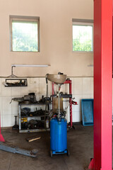 installation for vacuum oil change in a car. mechanic tools for car repair. auto service center