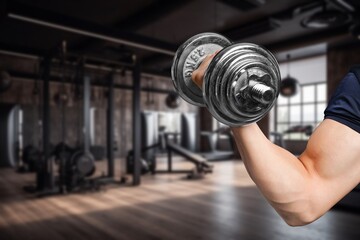 Serious man weightlifting in workout at indoor gym.