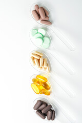 Various vitamin and mineral pills in transparent spoon food supplement health product