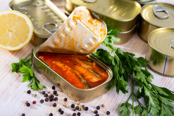 Image of pickled sardines in tomato sauce in open tin can, nobody
